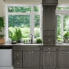 Dark Grey kitchen cabinets beneath a large window with a white quartz countertop