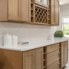 Cappuccino kitchen cabinets with a built-in wine rack and quartz countertop