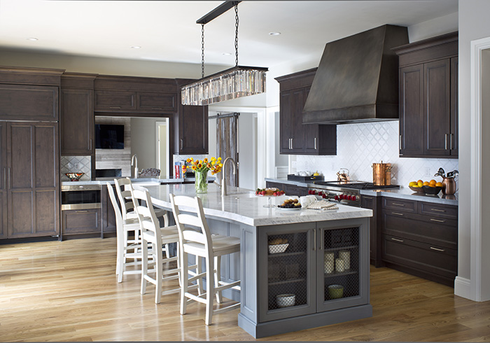 Dark Grey perimeter cabinets with a white island, wood hood and glass-front uppers