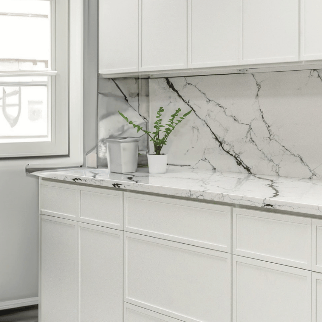 Mini White Shaker kitchen cabinets with a white marble backsplash and quartz countertop