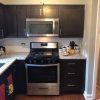 Espresso Shaker kitchen cabinets with a stainless range and granite countertop