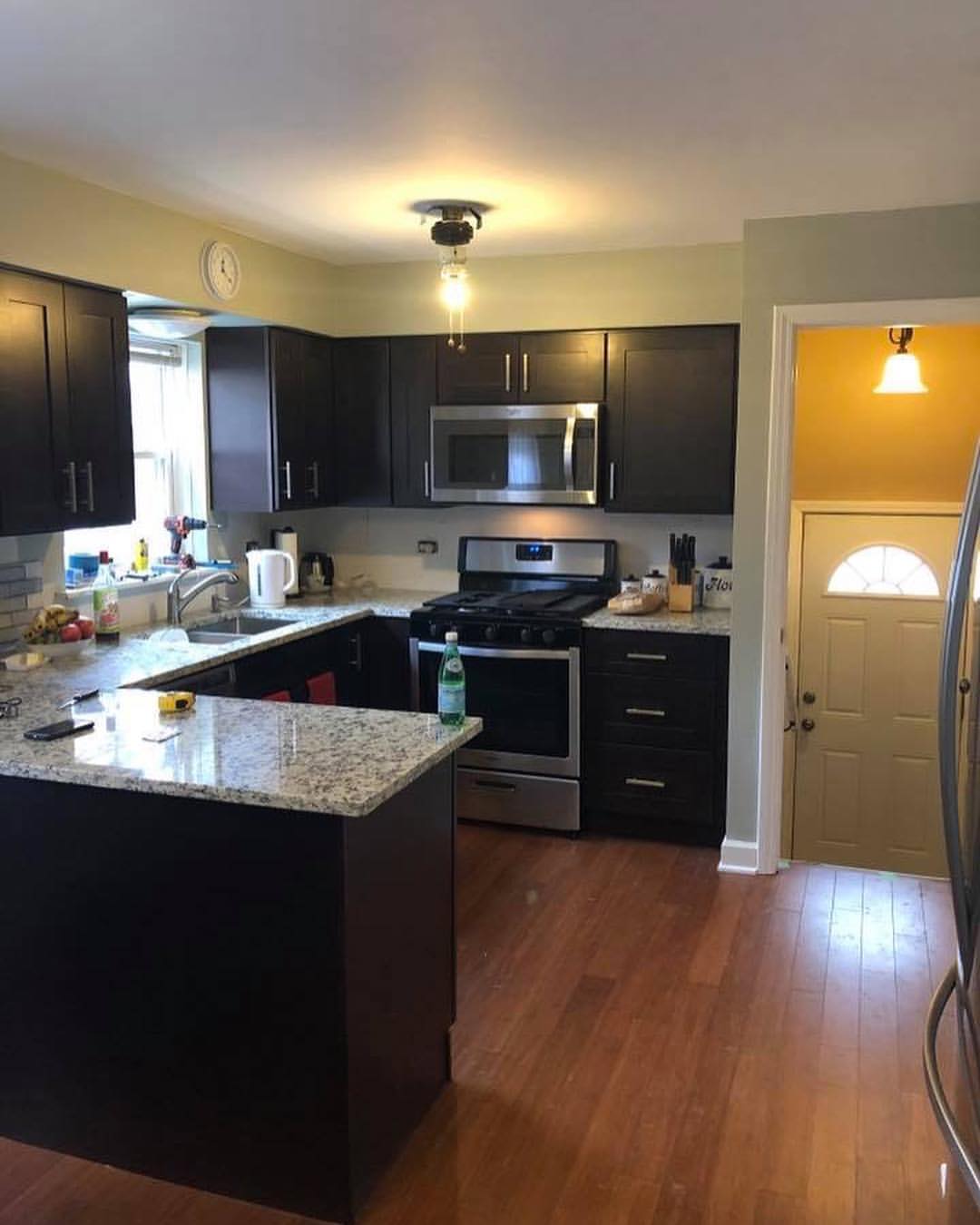 Espresso Shaker kitchen cabinets in a galley layout with granite countertops and hardwood floor