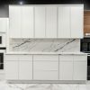 Mini White Shaker kitchen cabinets with a marble backsplash and built-in wall oven