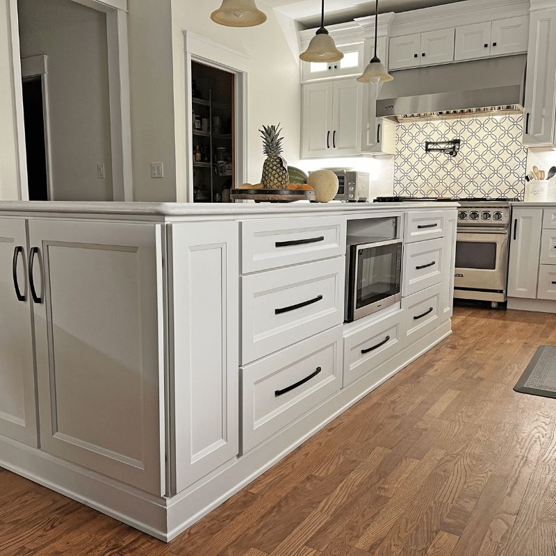 Millennium White slab-door kitchen cabinets by CCC Cabinets