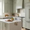 Matcha Latte kitchen cabinets by CCC Cabinets shown in an L-shaped kitchen with a centre island - flat shaker door in a soft muted sage, wholesale cabinetry in Des Plaines, Chicagoland