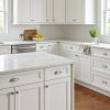 Millennium White kitchen cabinets by CCC Cabinets shown in an L-shaped kitchen with a centre island - raised-panel door in a clean painted white, wholesale cabinetry in Des Plaines, Chicagoland