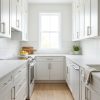 Pure White kitchen cabinets by CCC Cabinets shown in a narrow galley kitchen - flat shaker door in a bright painted white, wholesale cabinetry in Des Plaines, Chicagoland