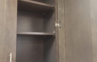 Dark Grey wall cabinet shown open with adjustable shelves and six-way soft-close hinges