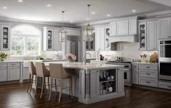 Millennium Off White kitchen cabinets with a large island, arched window and pendant lighting