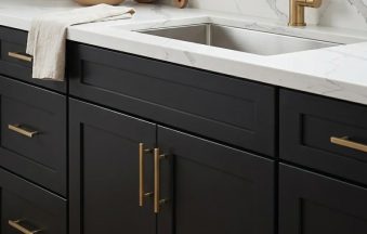 Black Roast kitchen cabinets by CCC Cabinets shown in a sink run beneath a bright window - flat shaker door in a true matte black, wholesale cabinetry in Des Plaines, Chicagoland