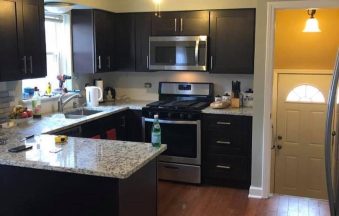Espresso Shaker kitchen cabinets in a galley layout with granite countertops and hardwood floor